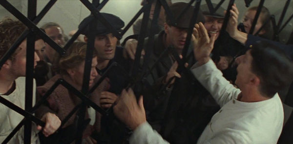 Still from the film Titanic, of lower class passengers being trapped behind metal gates